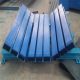 Conveyor load-zone impact bed with longitudinal bars and inclined side supports