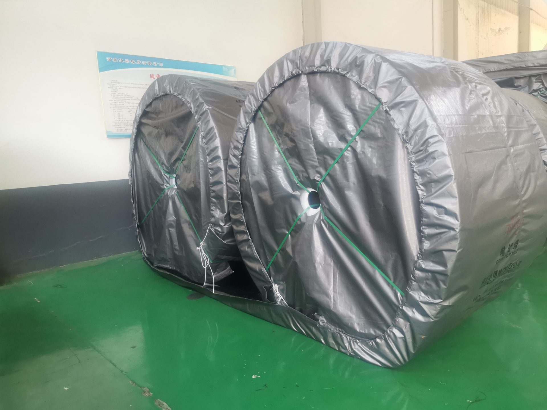 Wrapped conveyor belt rolls illustrating the need to preserve the actual heat-duty construction and joining identification