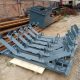 Self-aligning conveyor idler assembly with supporting frame and roller brackets