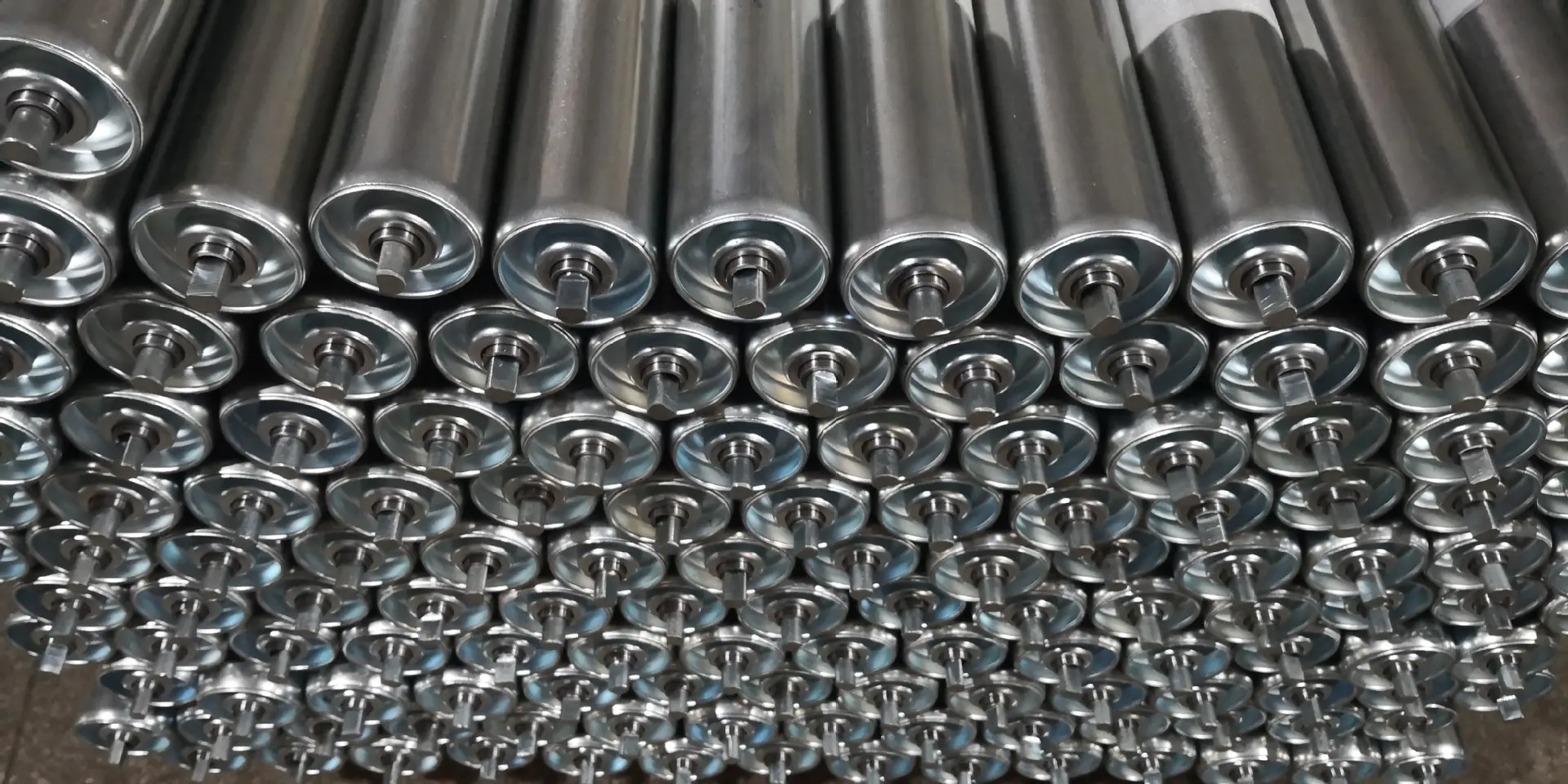 Steel conveyor roller bodies and shaft ends illustrating the components of a complete roller assembly