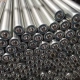 Steel conveyor rollers stacked with bearing ends and shaft interfaces visible